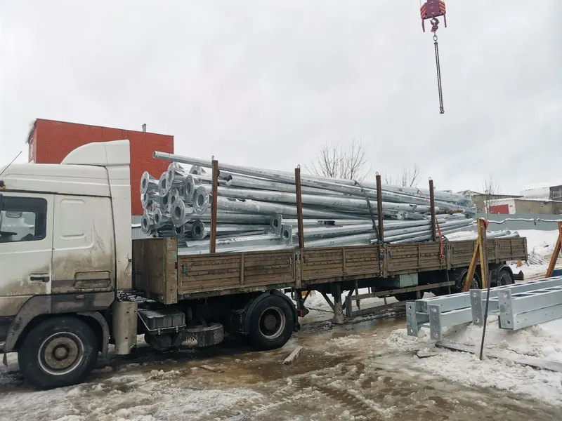Металлические стойки и профиль на бортовом полуприцепе во время крановой погрузки — БОРТ №1 Металлические стойки и профиль на бортовом полуприцепе во время крановой погрузки